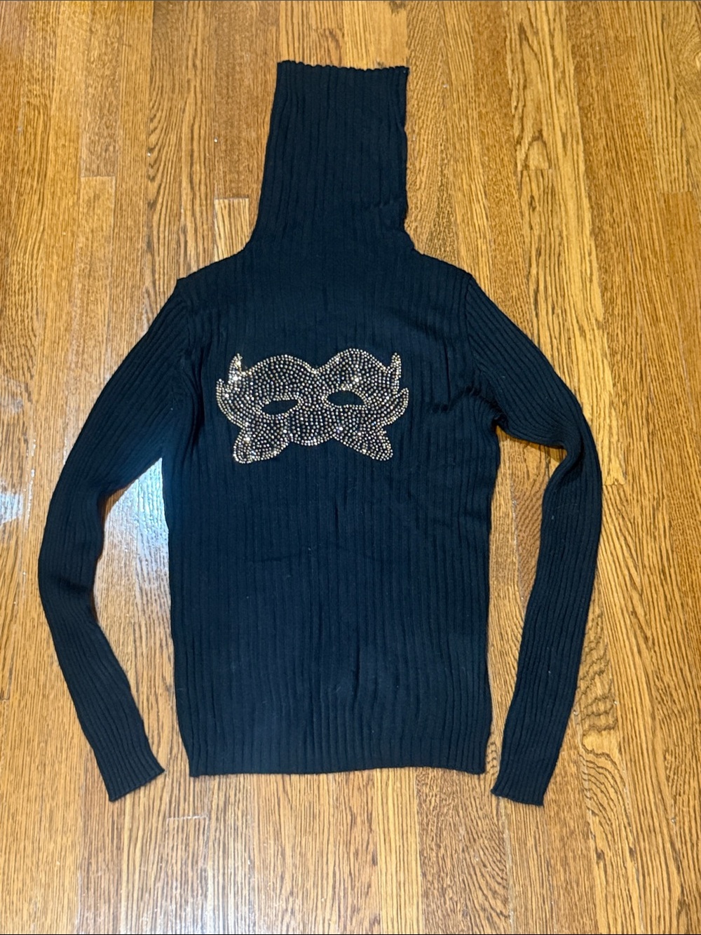 Brand new super soft black turtle neck with rhinestone detail.